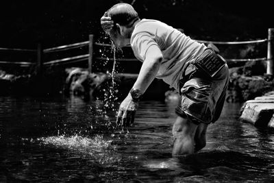Side view of man standing in water