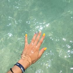 High angle view of woman hand in swimming pool