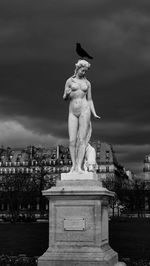 Statue of angel against cloudy sky