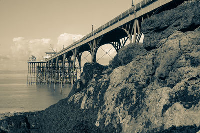 Arch bridge over river against sky