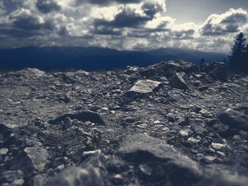 Close-up of rocks on land against sky