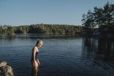 Senior woman swimming in lake