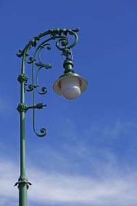 A very beautiful green lamppost with lots of ornaments