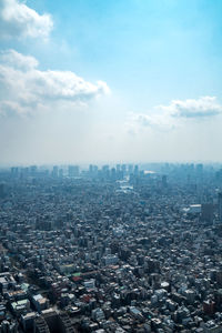 High angle view of city buildings against sky