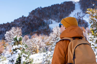 Rear view of woman standing against sky