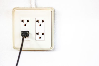 Close-up of outlet on white wall