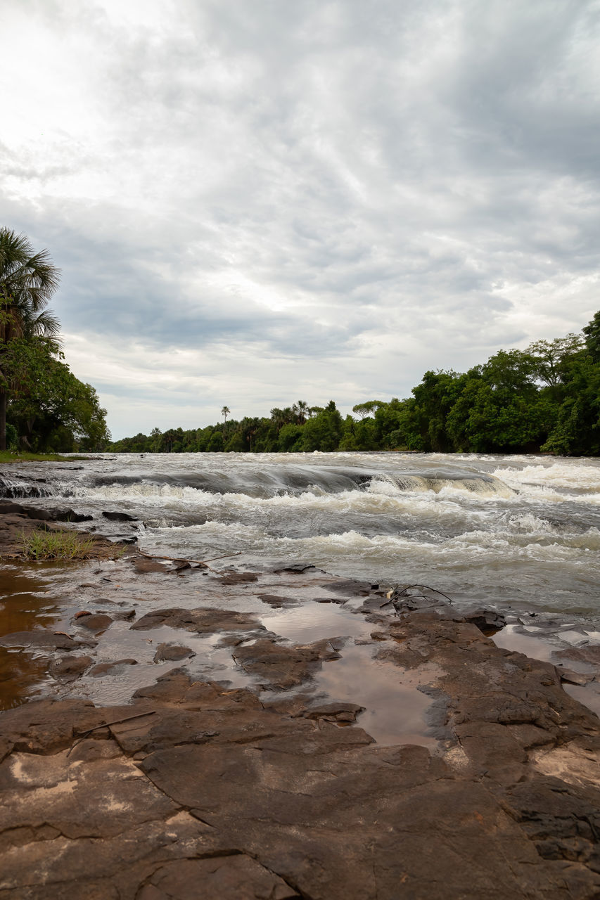 VIEW OF RIVER FLOWING THROUGH ROCKS