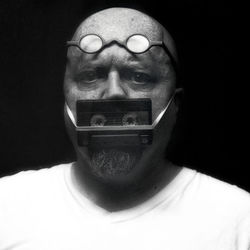 Close-up portrait of man with reflection against black background