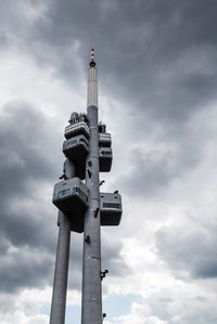 Low angle view of tower against cloudy sky