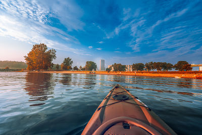 Cropped image of kayak in lake against blue sky