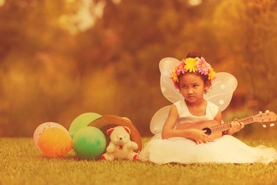 Cute boy playing with toy on field