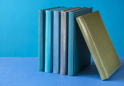 Close-up of books on blue table