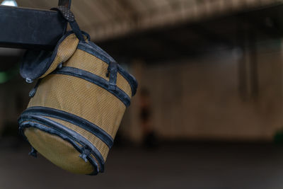 Close-up of lunch box hanging on metal