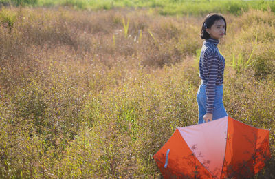 Side view of girl standing on field