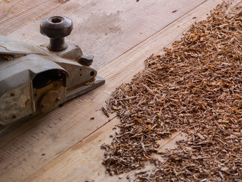 High angle view of old stack on wooden floor