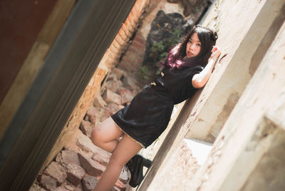 Portrait of woman lying down on staircase