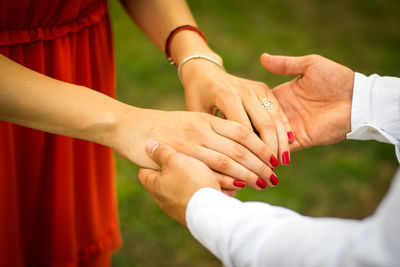 Midsection of couple holding hands