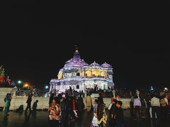 Group of people in front of building at night