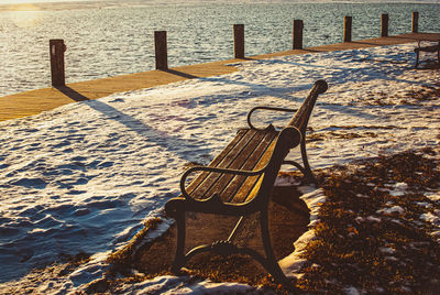 A warm sunrise at the park during winter with snow on the ground. 