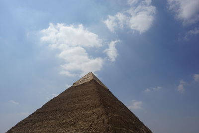 Low angle view of historical building against cloudy sky