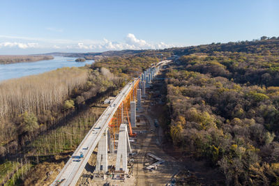 High angle view of road amidst trees against sky