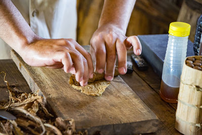 Midsection of man preparing food on table