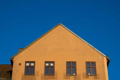 Low angle view of building against clear blue sky