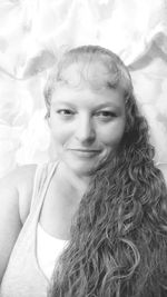 Portrait of happy woman with long hair at home