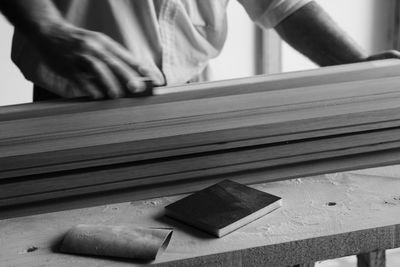 Close-up of carpenter working at desk