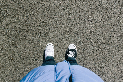 Low section of man with different shoes