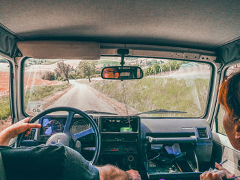 Man seen through car windshield