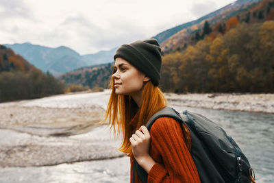 Beautiful young woman standing on mountain