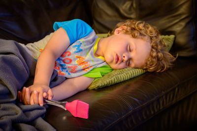 Cute boy lying on bed at home