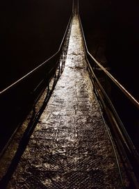 Low angle view of illuminated bridge against sky at night