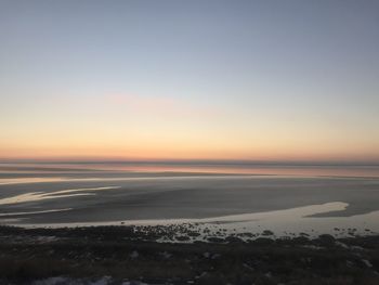 Scenic view of sea against clear sky during sunset