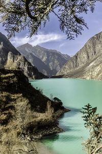 Scenic view of lake and mountains against sky