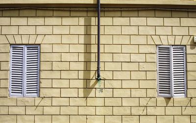 Low angle view of windows on wall of building