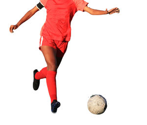 Low section of woman exercising against white background