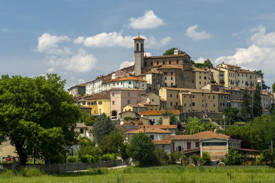 Buildings in town against sky