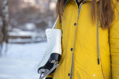 Close up of female hands holding ice skates.