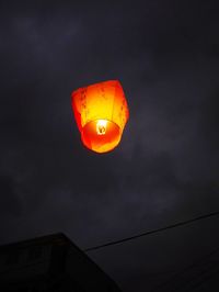 Low angle view of illuminated lantern against sky at sunset
