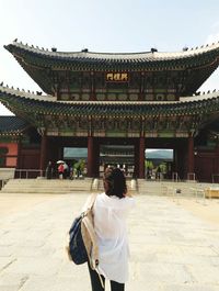 Rear view of a woman looking at temple