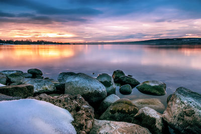 Scenic view of lake against sky during sunset