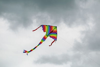 Low angle view of kite flying against sky