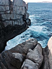 High angle view of rock formations by sea