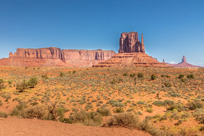 Rock formations on landscape against blue sky