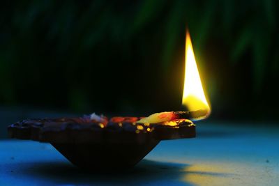 Close-up of burning diya