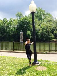 Full length of woman standing on field against sky