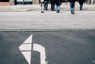 View of arrow sign on road