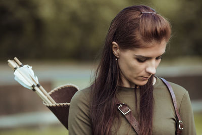 Portrait of a young woman looking down